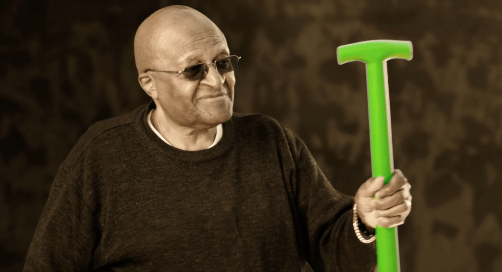 Desmond Tutu with shovel